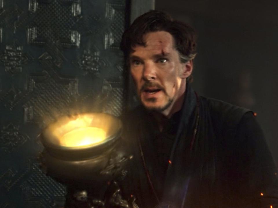 Doctor Strange holding a relic emitting light in "Doctor Strange."