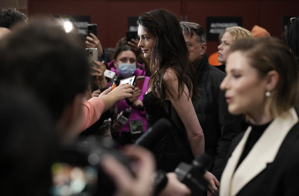 Anne Hathaway, center, a cast member in "Eileen," works the press line at the premiere of the film at the 2023 Sundance Film Festival, Saturday, Jan. 21, 2023, in Park City, Utah. (AP Photo/Chris Pizzello)