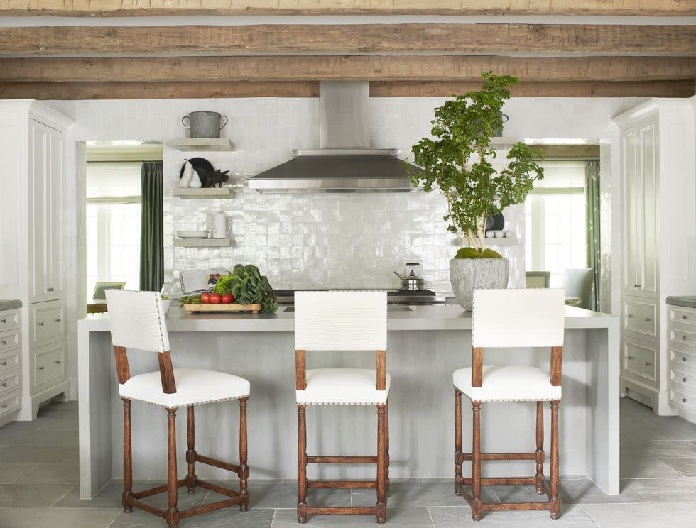 a white kitchen with tile backsplash