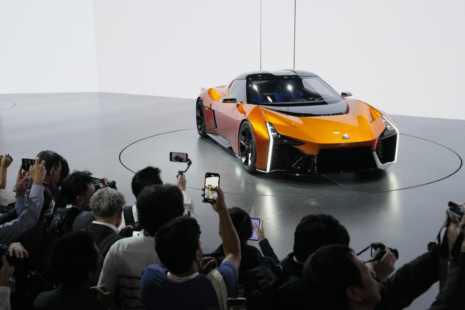 Media members and guests take pictures and film the FT-Se after Toyota Motor Corp. CEO Koji Sato speaks during a briefing on the media day at the Japan Mobility Show in Tokyo, Wednesday, Oct. 25, 2023. (AP Photo/Hiro Komae)