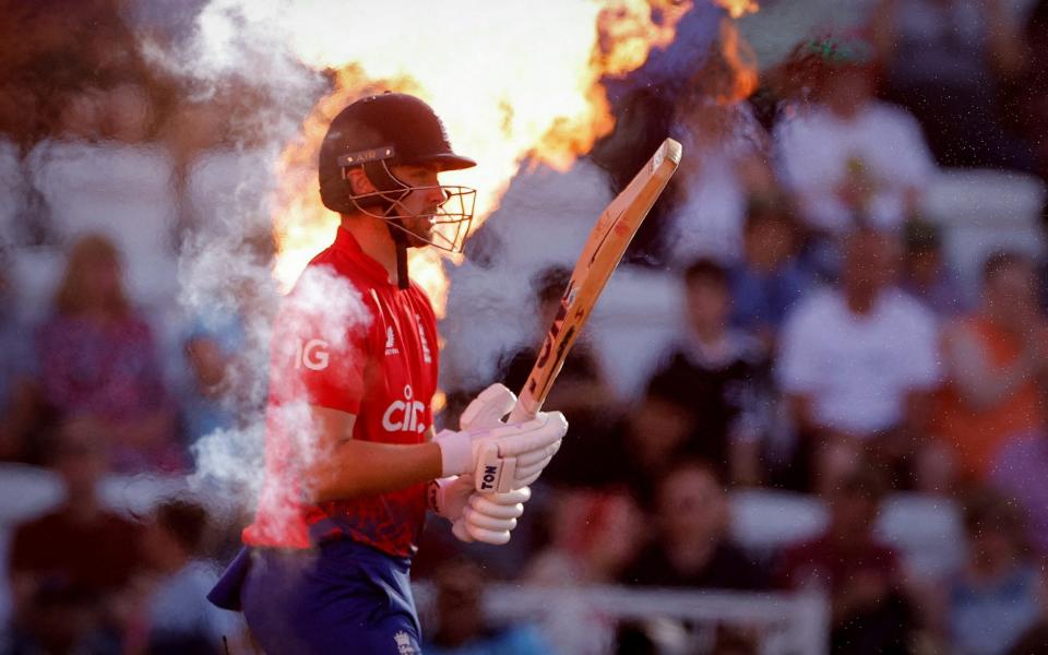 England's Will Jacks walks out as fire sprays behind him before the start