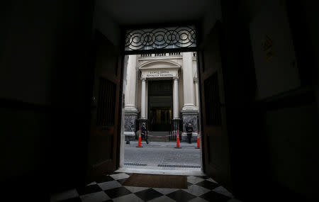 Pedestrian walks past Argentina's Central Bank facade, in Buenos Aires, Argentina March 26, 2019. REUTERS/Agustin Marcarian