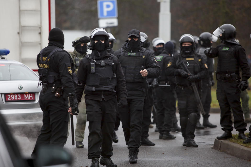 Belarusian riot police gather to block demonstrators during an opposition rally to protest the official presidential election results in Minsk, Belarus, Sunday, Nov. 22, 2020. The Belarusian human rights group Viasna says more than 140 people have been arrested and many of them beaten by police during protests calling for the country's authoritarian president to resign. The demonstrations that attracted thousands were the 16th consecutive Sunday of large protests against President Alexander Lukashenko. (AP Photo)