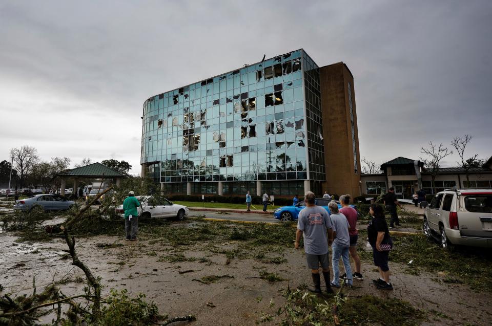 People survey damage following a tornado at the Iberia Medical Center, Wednesday, Dec. 14, 2022, in New Iberia, Louisiana.