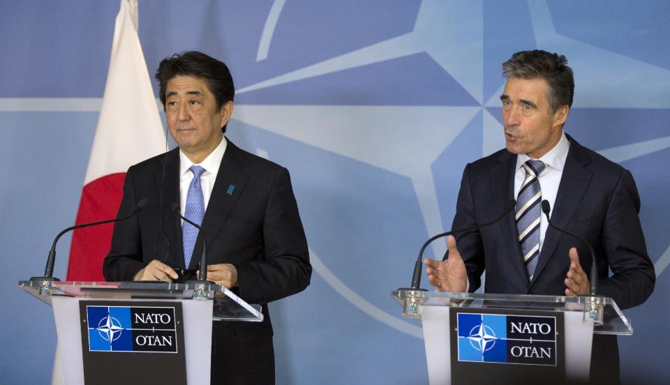 Japan's Prime Minister Shinzo Abe, left, and NATO Secretary General Anders Fogh Rasmussen participate in a media conference at NATO headquarters in Brussels on Tuesday, May 6, 2014. Abe will, in a two-day visit, meet with NATO, EU and Belgian officials. (AP Photo/Virginia Mayo)