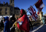 A protester yells "freedom" towards a person who attempted to stick a paper sign on a truck criticizing the so called "Freedom Convoy," a protest against COVID-19 measures that has grown into a broader anti-government protest, on its 18th day, in Ottawa, on Monday, Feb. 14, 2022. (Justin Tang/The Canadian Press via AP)