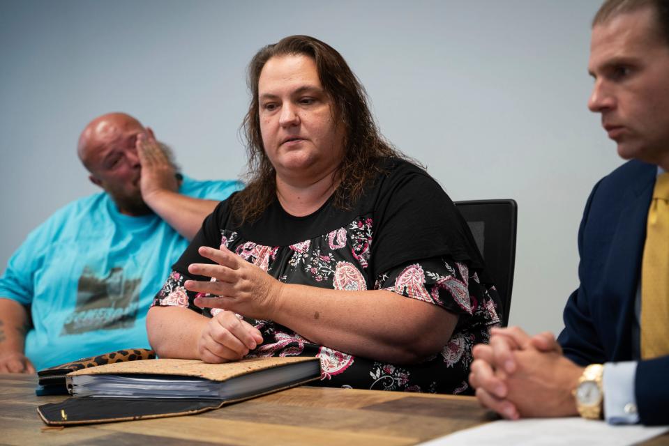 Robert Neely, 37, left, his wife Crystal Neely, 43, and attorney Jonathan Marko discuss a lawsuit related to the death of Christopher Neely at Marko Law Firm in downtown Detroit on Friday, July 21, 2023. Christopher Neely is one of multiple prisoners who were murdered in separate incidents at Macomb Correctional Facility.