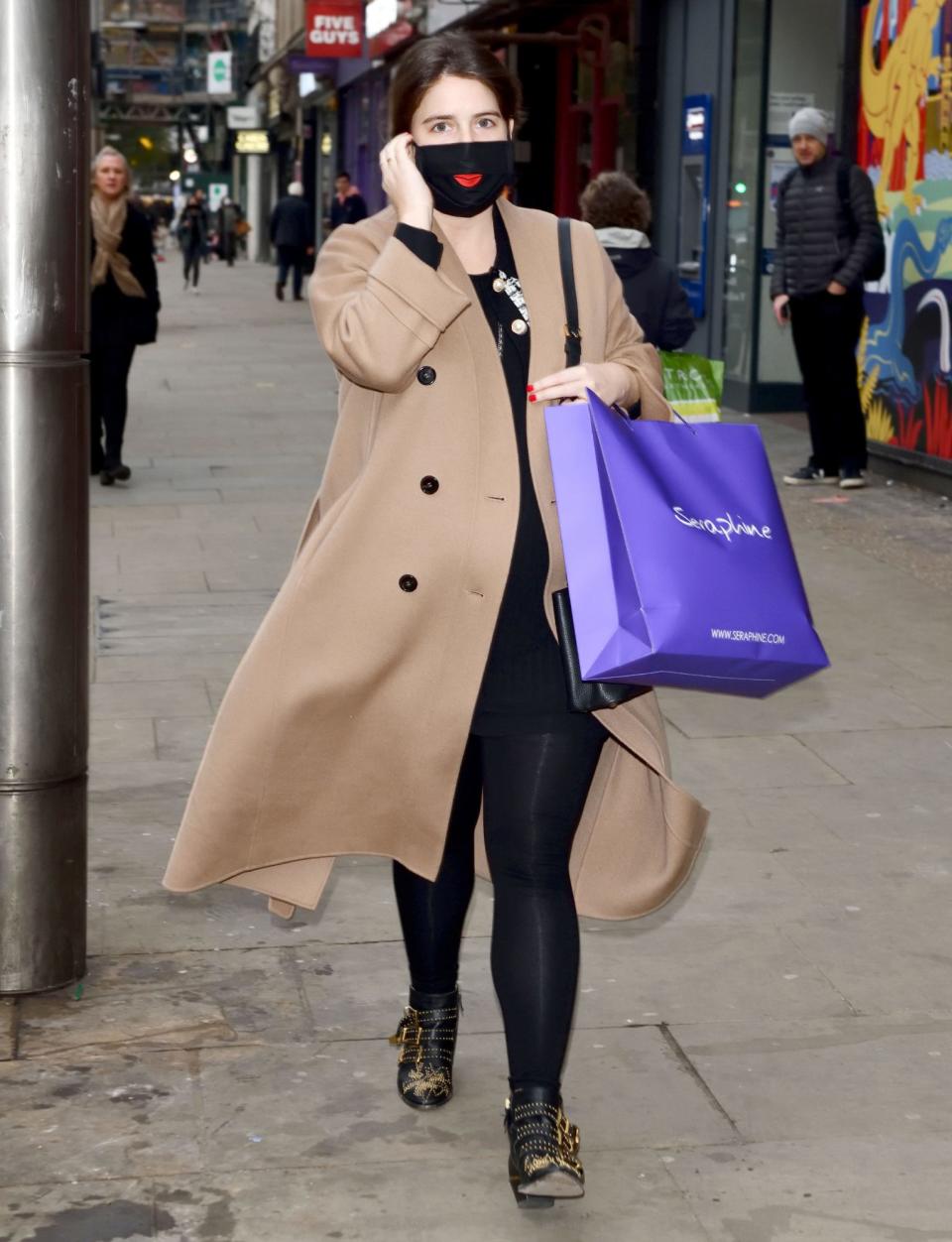 <p>Princess Eugenie leaves Seraphine on Kensington High Street with a bag full of goodies after the store reopened on the first day after lockdown in London on Wednesday. </p>