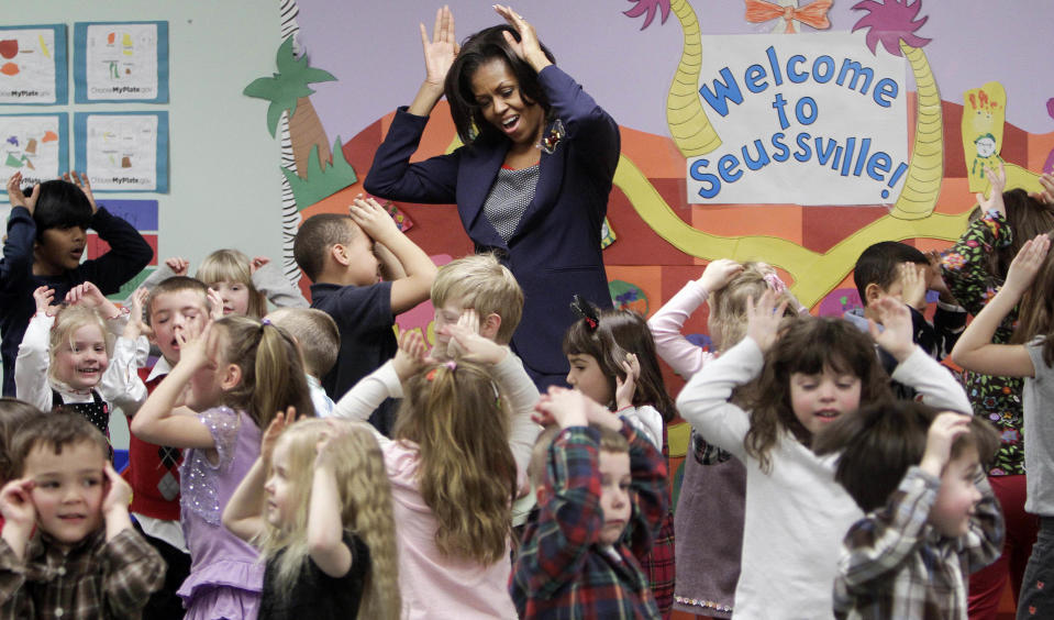 FILE - In this Friday, March 9, 2012 file photo, first lady Michelle Obama does a bunny hop dance with pre-schoolers at the Penacook Community Center in Concord, N.H., as part of her Let's Move initiative. A new study published in the New England Journal of Medicine on Wednesday, Jan. 29, 2014 finds that much of a child's "weight fate" is set by age 5, and that nearly half of kids who became obese by the eighth grade were already overweight when they started kindergarten. Researchers think there may be a window of opportunity to prevent it, and "we keep pushing our critical window earlier and earlier on," said Solveig Cunningham, a scientist at Emory University. (AP Photo/Jim Cole)