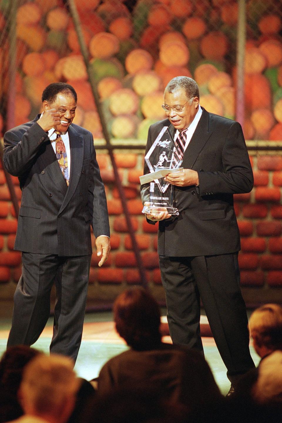 1993: Baseball Hall of Famer Willie Mays accepts a tributary award from actor James Earl Jones during taping of the 