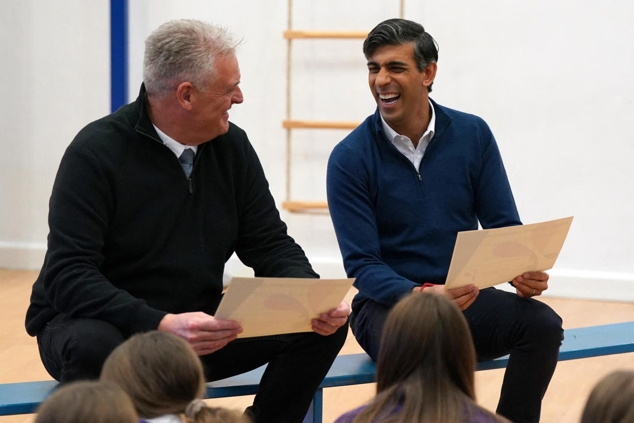 Britain's Prime Minister Rishi Sunak (R) and Conservative Party Deputy Chairman, and MP for Ashfield, Lee Anderson, react as they talk with school children as they visit to Woodland View Primary School in Sutton-in-Ashfield, central England on January 4, 2024. (Photo by Jacob King / POOL / AFP) (Photo by JACOB KING/POOL/AFP via Getty Images)