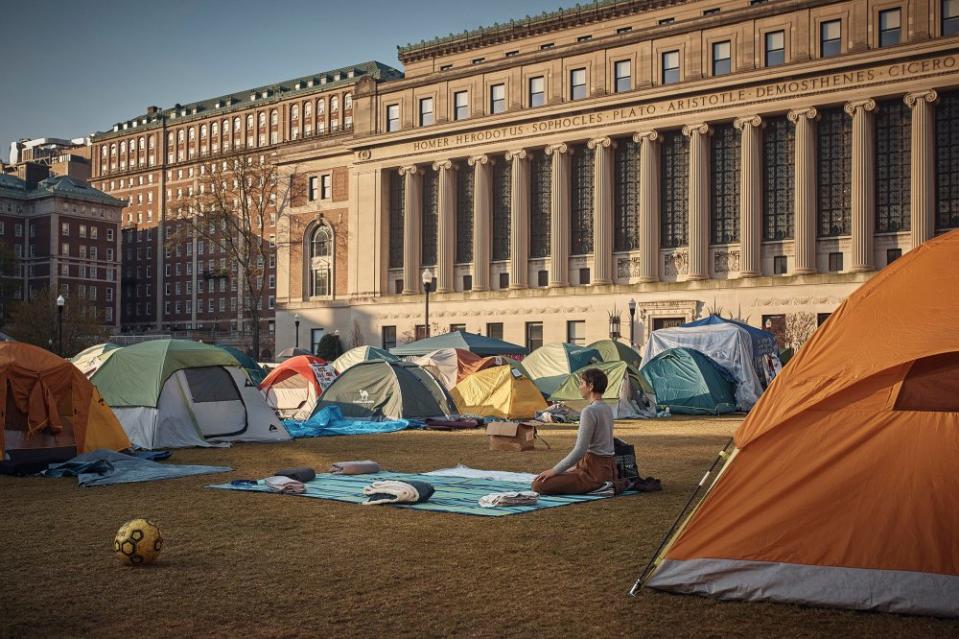 A protestor meditates early Monday morning inside the pro-Palestinian encampment on Columbia University campus. <span class="copyright">Andres Kudacki for TIME</span>