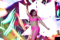 <p>On the first day, Ashanti lit up the stage in a hot pink off-shoulder catsuit with sheer inserts throughout the bodice and pants.</p>