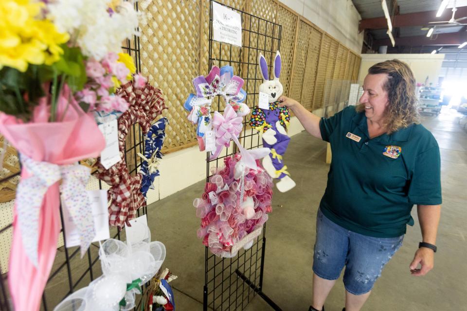 Jill Sterling, vice president of the senior fair board, arranges crafts for display in the art hall at the Stark County Fair. Fair events kick off Tuesday and run through Labor Day.
