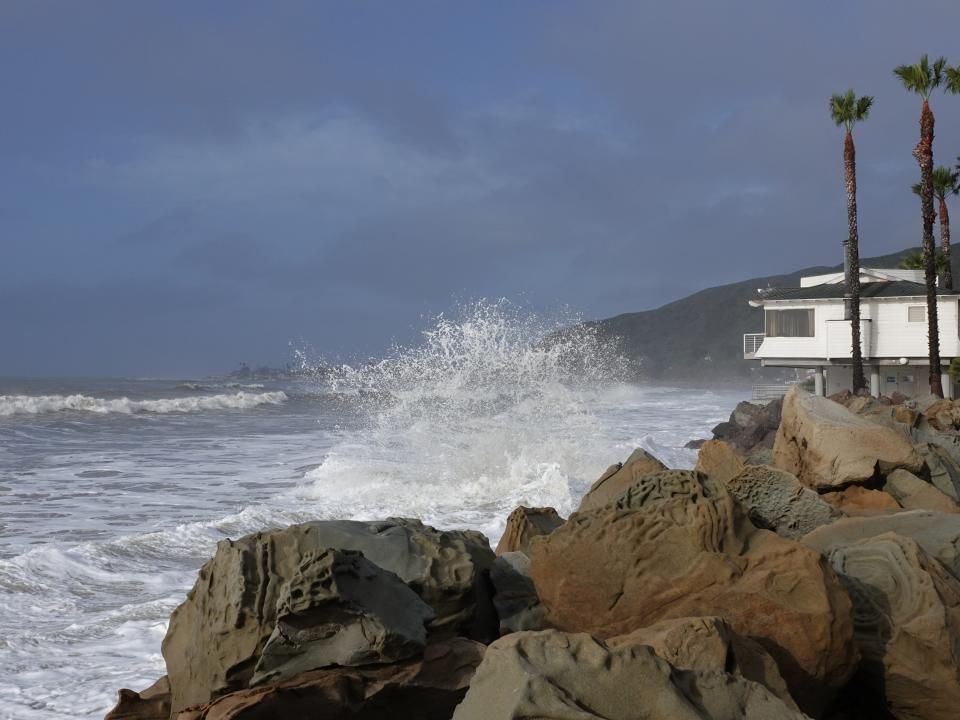 Ocean spray bounces from the rocky seawall along old Pacific Coast Highway north of Ventura amid strong surf as a storm moved through the area Thursday morning.