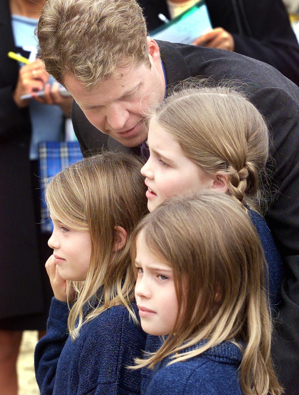 Earl Spencer and his daughters, including Kitty (centre) (AFP via Getty Images)