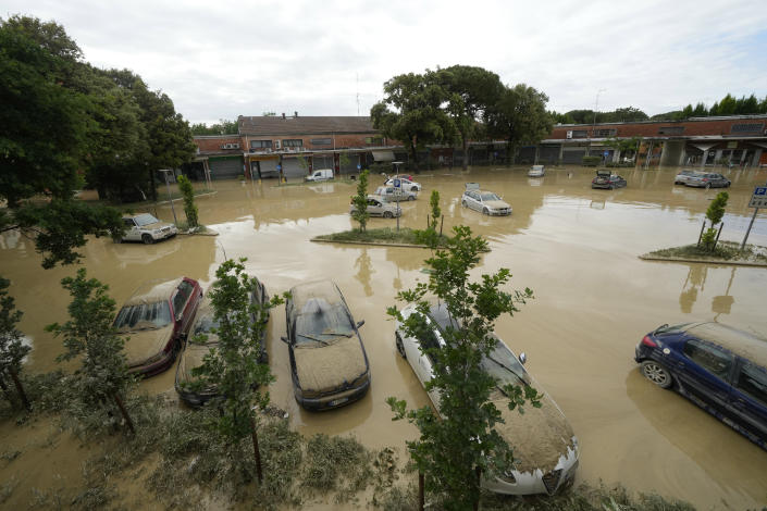 Mud covers cars in parking place in Faenza, Italy, Thursday, May 18, 2023. Exceptional rains Wednesday in a drought-struck region of northern Italy swelled rivers over their banks, killing at least nine people, forcing the evacuation of thousands and prompting officials to warn that Italy needs a national plan to combat climate change-induced flooding. (AP Photo/Luca Bruno)