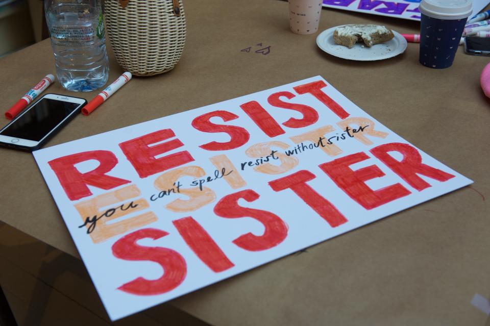 Marchers make signs at women's co-working space and social club, The Wing.