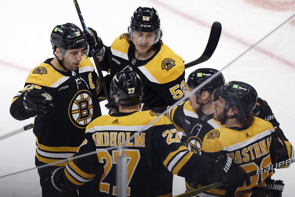 Boston Bruins' Patrice Bergeron (37) celebrates his goal with teammates during the first period of an NHL hockey game against the Tampa Bay Lightning, Saturday, March 25, 2023, in Boston. (AP Photo/Michael Dwyer)