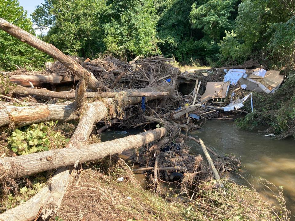 Debris is shown on Pole Creek in Buncombe County.