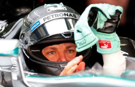 Mercedes' Nico Rosberg puts on his gloves in the pit during practice. Formula One - F1 - Malaysian Grand Prix 2015 - Sepang International Circuit, Kuala Lumpur, Malaysia - 27/3/15 REUTERS/Olivia Harris