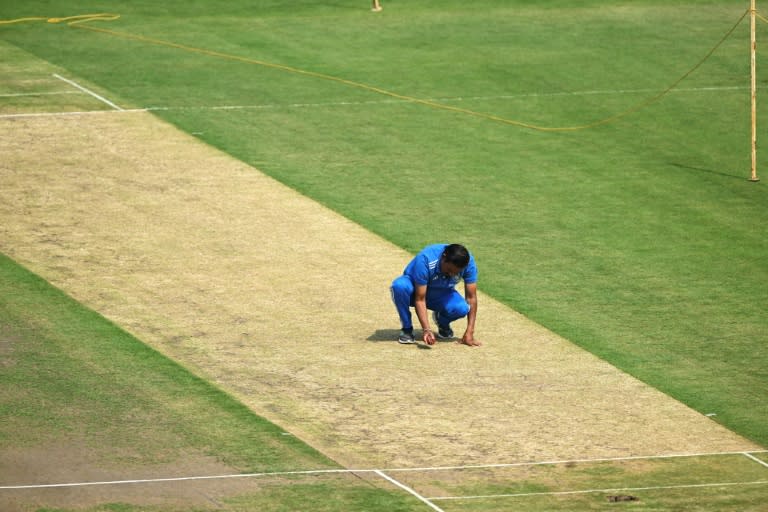 An India team official inspects the pitch at Ranchi on the eve of the fourth Test (Tauseef MUSTAFA)