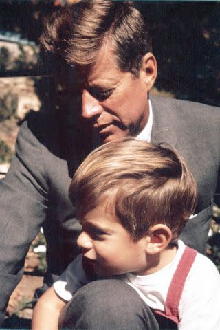 <p>Estate of Stanley Tretick LLC/Corbis via Getty</p> A young John Jr. and his father, President John F. Kennedy.