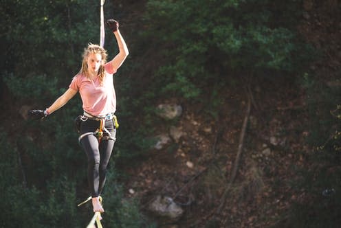 <span class="caption">Navigating risk can feel like walking on a tightrope, even when you're perfectly safe.</span> <span class="attribution"><a class="link " href="https://www.shutterstock.com/image-photo/woman-walking-along-stretched-sling-highline-1733506469" rel="nofollow noopener" target="_blank" data-ylk="slk:zhukovvvlad/Shutterstock;elm:context_link;itc:0;sec:content-canvas">zhukovvvlad/Shutterstock</a></span>