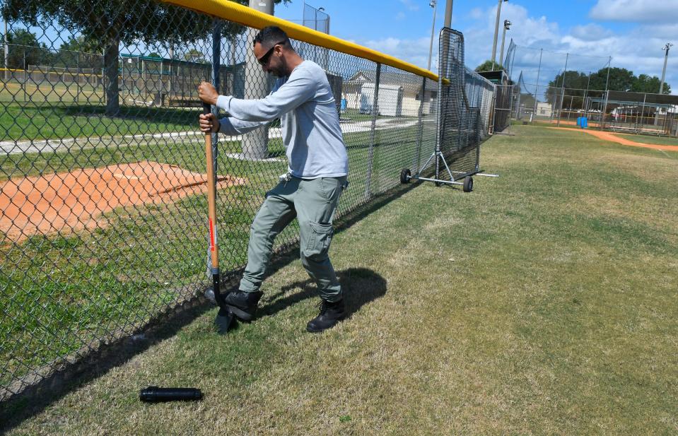  Brevard County Parks & Recreation maintenance technician Todd Sharpe replacing a defective sprinkler head at a ball field at the athletic complex near Suntree Elementary.