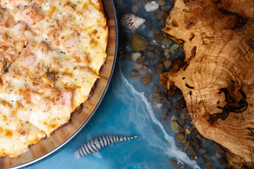 A seafood pizza is seen on a custom made ocean-themed bar top at Waves Bar, located in the King-Lincoln Bronzeville neighborhood.