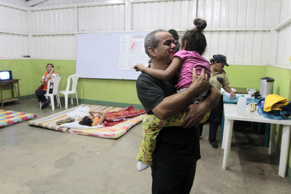 A man holds his daughter inside an evacuation center in Managua after an earthquake shook Nicaragua October 13, 2014. (REUTERS/Oswaldo Rivas)