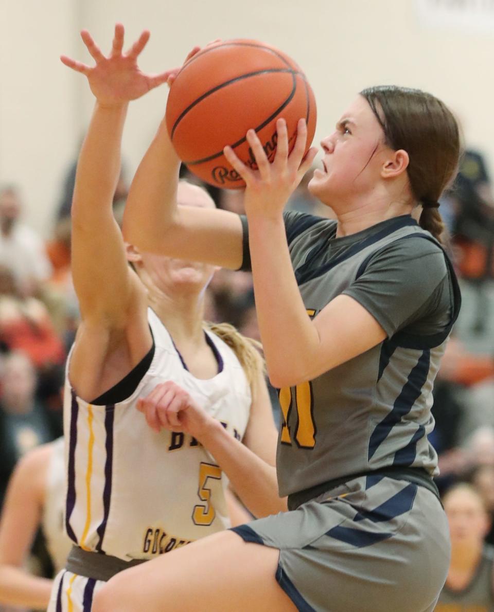 Copley's Evelyn McKnight goes to the hoop under pressure from Bryan's Anna Gray in the OHSAA Division II Regional final game at Mansfield High School on Friday March 8, 2024.