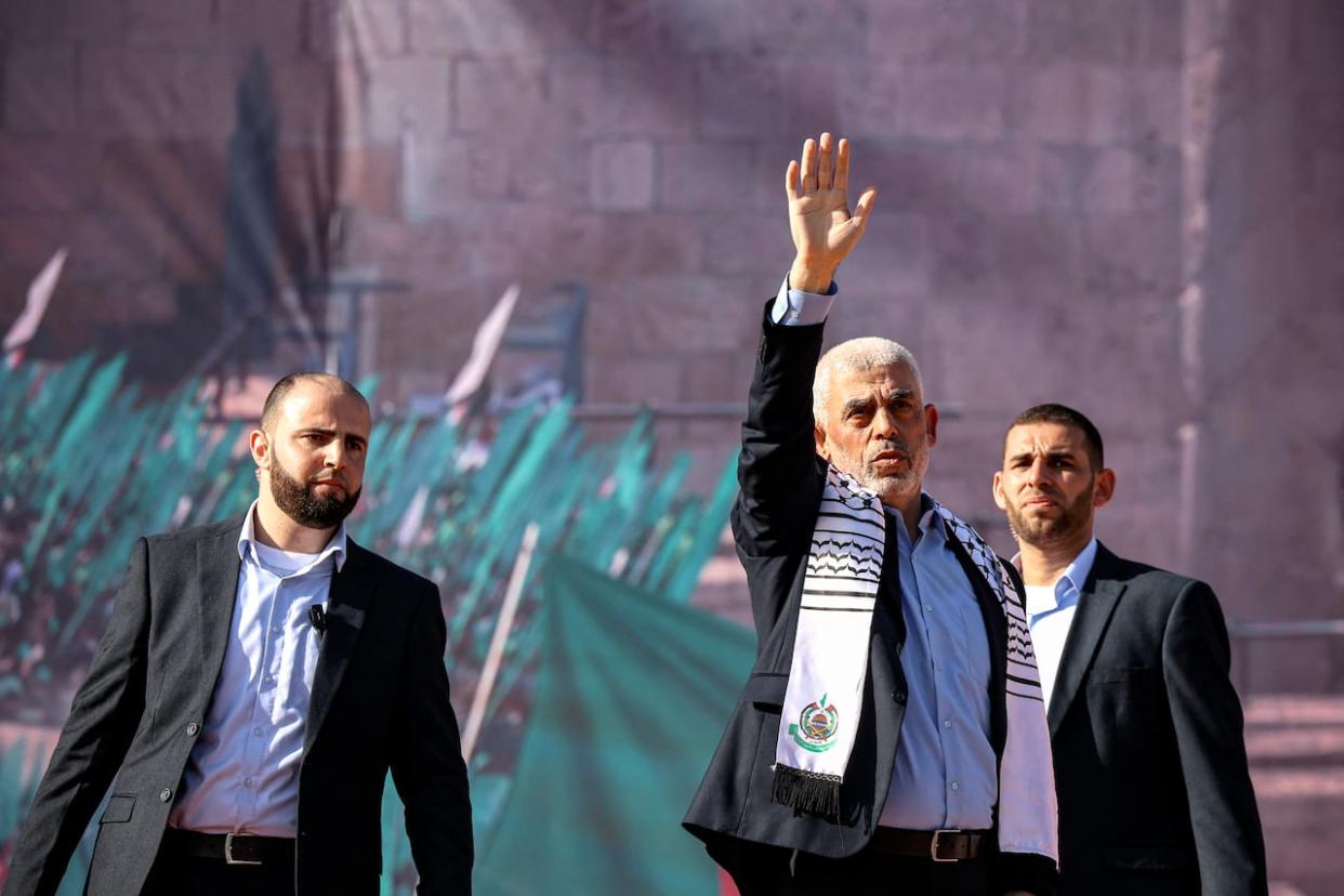 Yahya Sinwar, centre, seen in a file photo from 2022, is co-founder of the military wing of Hamas and considered the architect of the Oct. 7 attacks on Israel. He remains alive and presumably hiding in Gaza, despite Israel's stated war aim of eliminating Hamas. (Mohammed Abed/AFP via Getty Images) - image credit)