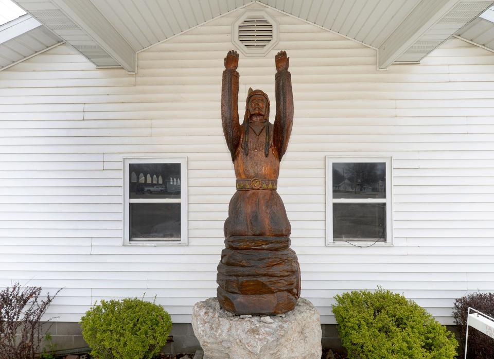 A wood-carved statue of Nokomis, named after a poem from Henry Wadsworth Longfellow, stands outside Stiehl-Dawson Funeral Home in Nokomis, Ill. on Wednesday, March 27, 2024.