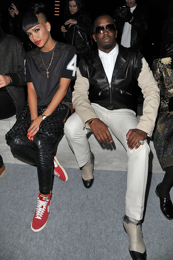 Cassie and Diddy sit next to each other during a Paris Fashion Week event in 2012.