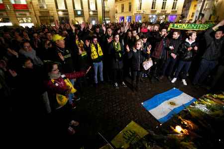 Fans gather near a row of yellow tulips in Nantes' city center after news that newly-signed Cardiff City soccer player Emiliano Sala was missing after the light aircraft he was travelling in disappeared between France and England the previous evening, according to France's civil aviation authority, France, January 22, 2019. REUTERS/Stephane Mahe