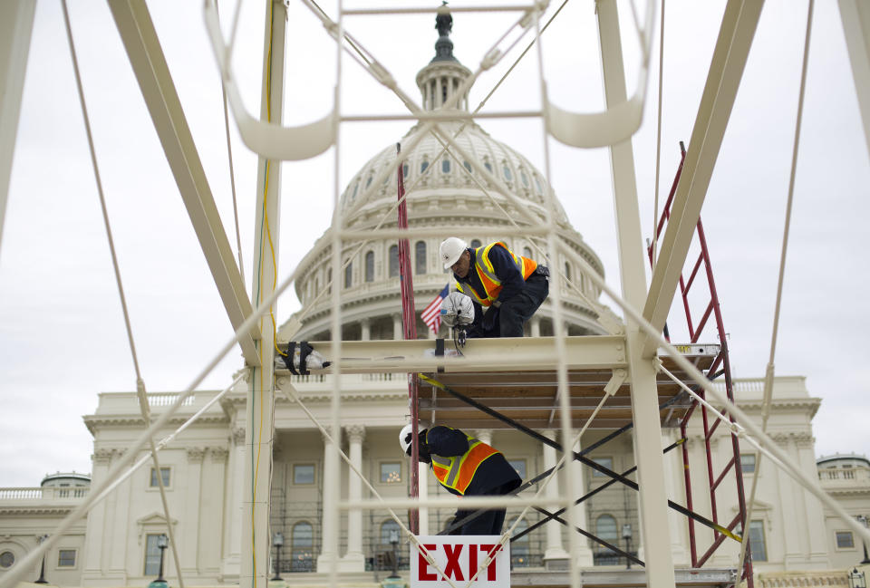 FILE - In this Dec. 8, 2016 file photo, construction continues on the Inaugural platform in preparation for the Inauguration and swearing-in ceremonies for President-elect Donald Trump, on the Capitol steps in Washington. Trump’s Presidential Inaugural Committee has raised a record $90 million-plus in private donations, far more than President Barack Obama’s two inaugural committees. They collected $55 million in 2009 and $43 million in 2013, and had some left over on the first go-round. But while Trump has raised more money for his inauguration than any president in history, he’s aiming to do less with it. (AP Photo/Pablo Martinez Monsivais, File)