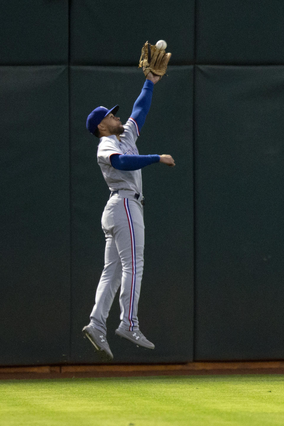 Texas Rangers left fielder Jason Martin catches a line drive by Oakland Athletics' Matt Chapman during the fifth inning of a baseball game Friday, Aug. 6, 2021, in Oakland, Calif. (AP Photo/D. Ross Cameron)