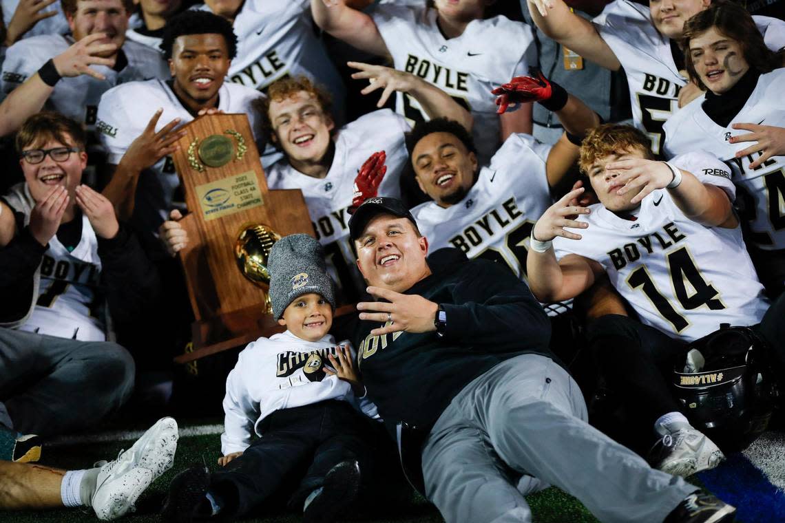 Boyle County head coach Justin Haddix, center, celebrated with his team and son after the Rebels defeated Covington Catholic for the program’s fourth straight KHSAA Class 4A state football championship at Kroger Field last fall.