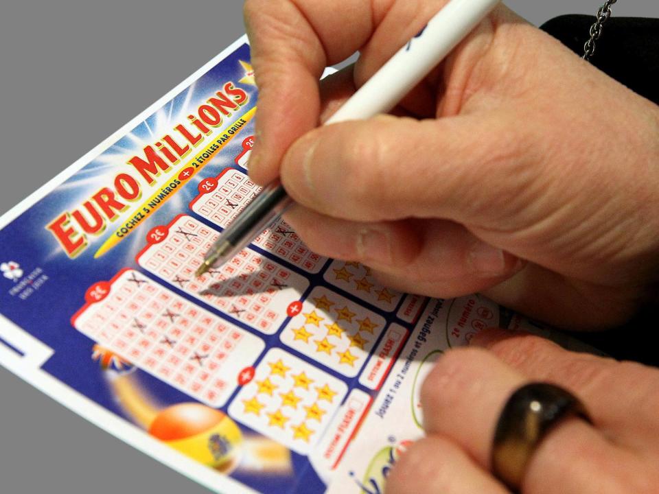 Woman fills out   Euromillions lottery form, Bayonne,   France,  graphic element on gray