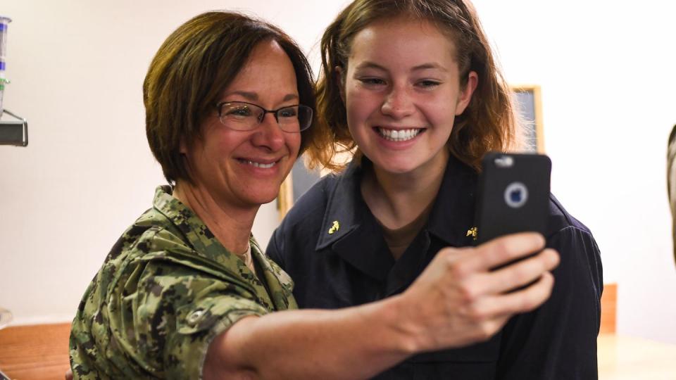 Then-Vice Adm. Lisa Franchetti, commander of U.S. 6th Fleet, takes a selfie with Midshiman 1st Class Elise Vincent while visiting the destroyer Bainbridge in June 2018. (MC1 Theron Godbold/U.S. Navy)