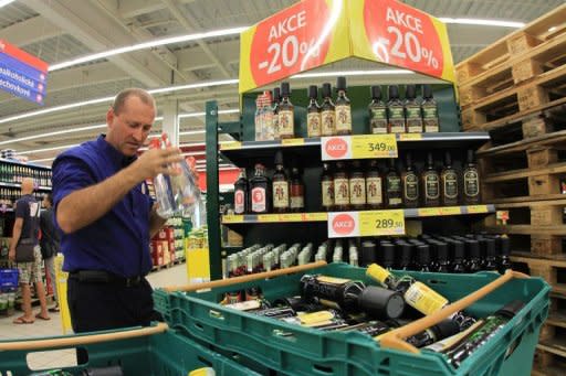 An employee of a supermarket removes alcohol from the shelves in Brno on September 14 after the government announced a prohibition on alcohol more than 20 percent proof. Czech bars and drink producers were counting losses Wednesday as a blanket ban on spirits sales has trimmed their earnings amid an unprecedented wave of alcohol poisonings that has claimed 23 lives