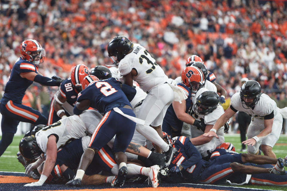 Army running back Jakobi Buchanan, center, scores a touchdown during the first half of an NCAA college football game against Syracuse in Syracuse, N.Y., Saturday, Sept. 23, 2023. (AP Photo/Adrian Kraus)