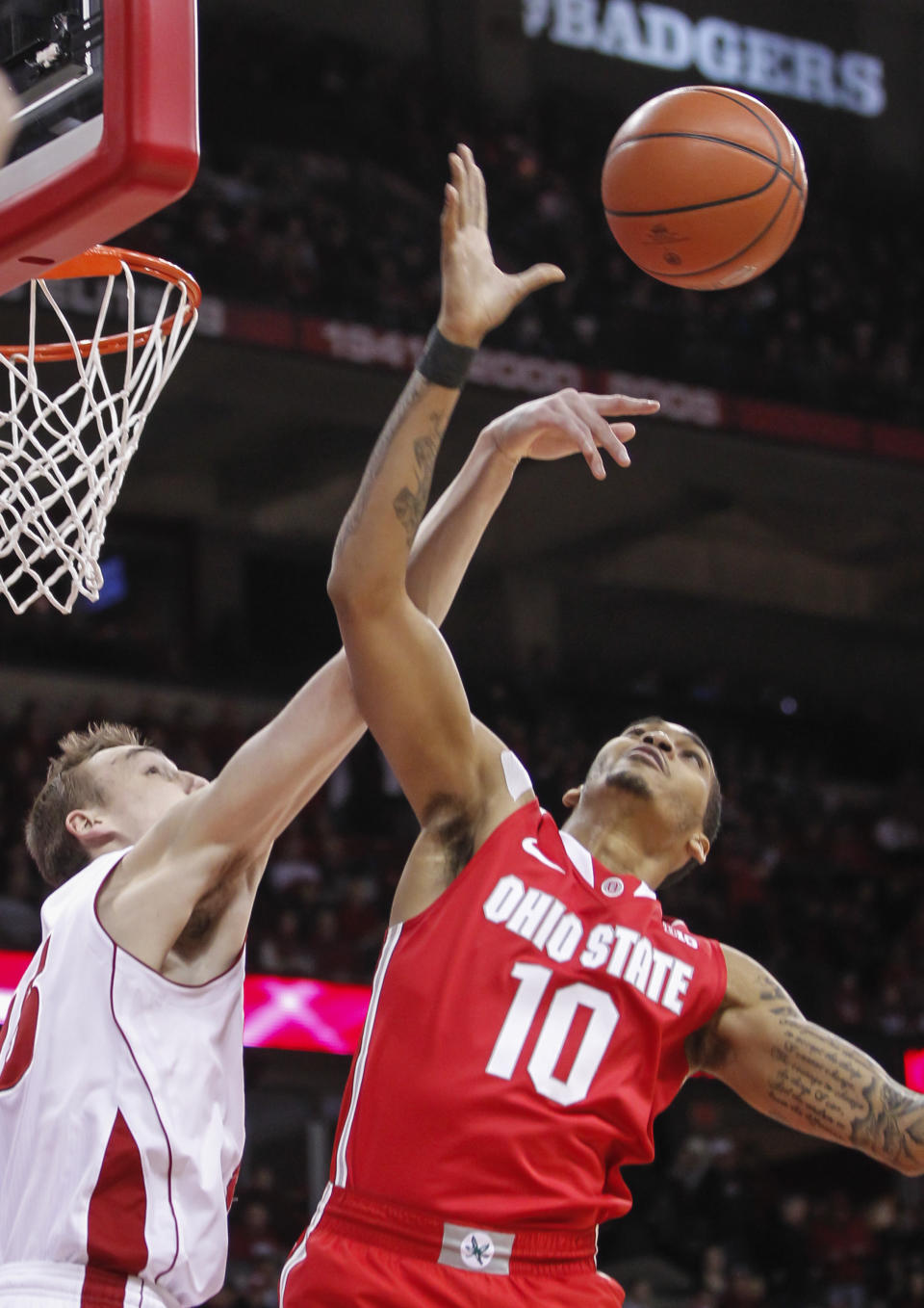 Wisconsin's Sam Dekker, left, knocks the ball away from Ohion State's LaQuinton Ross during the first half of an NCAA college basketball game Saturday, Feb. 1, 2014, in Madison, Wis. (AP Photo/Andy Manis)