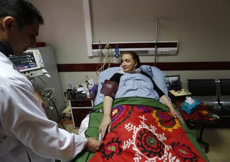 Afghan member of parliament Shukria Barakzai, receives treatment at a hospital after having survived an attack on November, in Kabul December 27, 2014. REUTERS/Mohammad Ismail