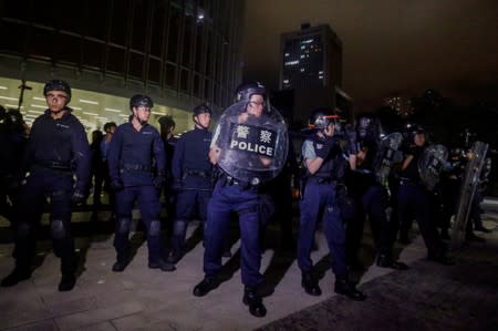 Riot police officers stand guard outside the Legislative Council during a protest to demand authorities scrap a proposed extradition bill with China in Hong Kong