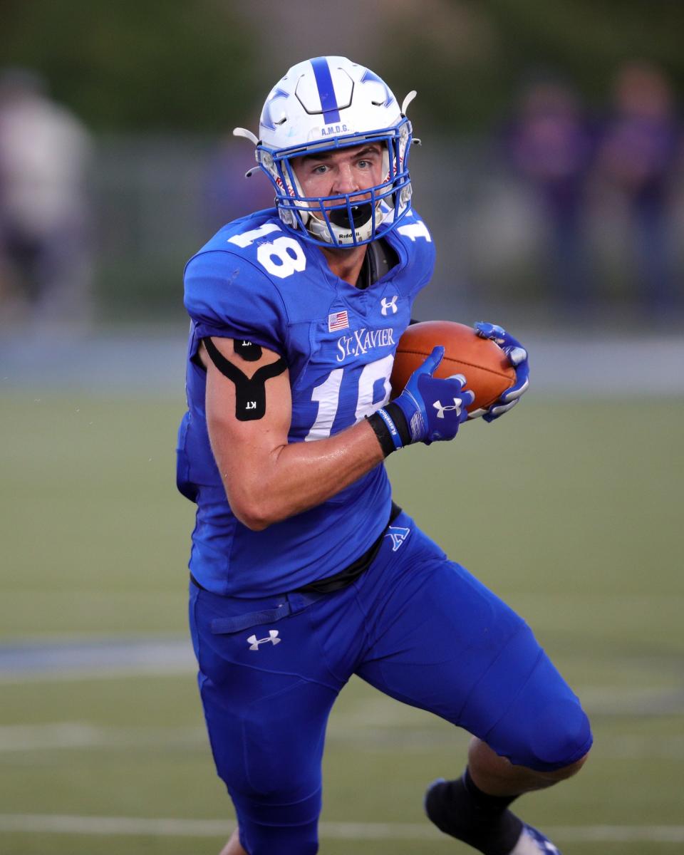 St. Xavier tight end Max Klare runs for a first down after a catch in the game between the Elder and St. Xavier high schools Sept. 24, 2021.