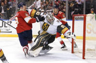 Florida Panthers center Sam Bennett (9) runs into Vegas Golden Knights goaltender Robin Lehner (90) during the second period of an NHL hockey game, Thursday, Jan. 27, 2022, in Sunrise, Fla. Bennett was penalized for goalie interference on the play. (AP Photo/Lynne Sladky)