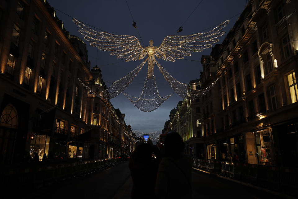 The Regent Street Christmas lights entitled 'The Spirit of Christmas' stand illuminated after being switched on yesterday without a ceremony as shops on the street lie temporarily closed due to England's second coronavirus lockdown, in London, Sunday, Nov. 15, 2020. This week saw Britain on Wednesday become the fifth country in the world to record more than 50,000 coronavirus-related deaths and on Thursday to record 33,470 people testing positive for COVID-19, the highest daily number of new cases since the virus first struck. (AP Photo/Matt Dunham)