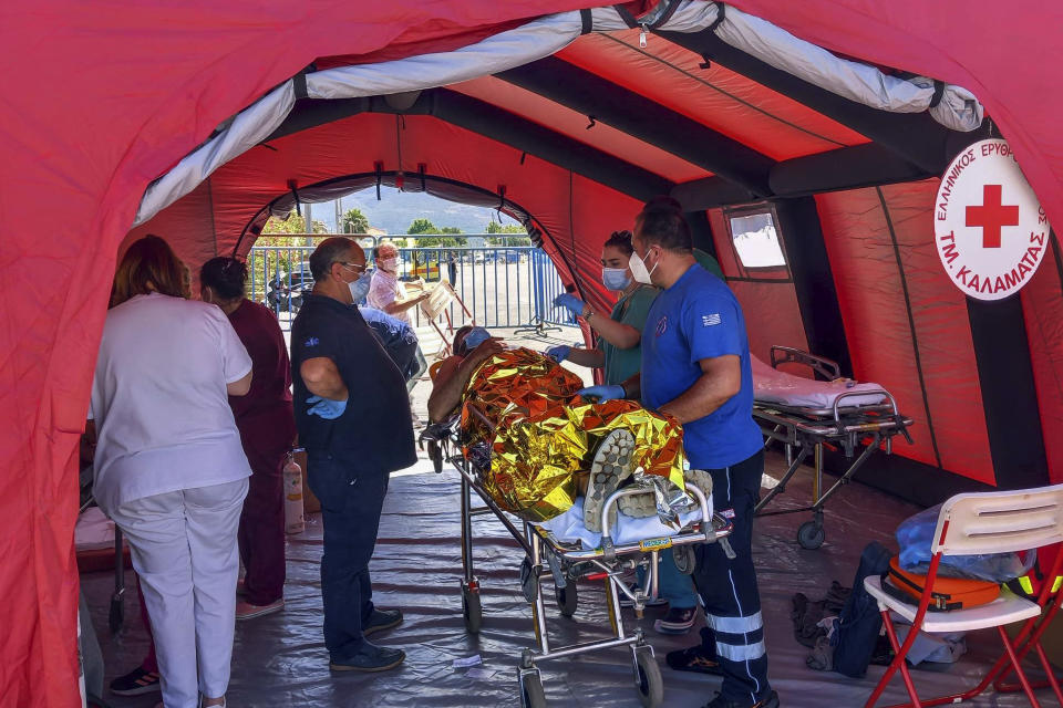 A survivors receives first aid after a rescue operation at the port in Kalamata town, about 240 kilometers (150miles) southwest of Athens on Wednesday, June 14, 2023. Authorities say at least 70 people have died and dozens are feared missing off the coast of southern Greece after a fishing boat carrying migrants capsized and sank. (www.argolikeseidhseis.gr via AP)